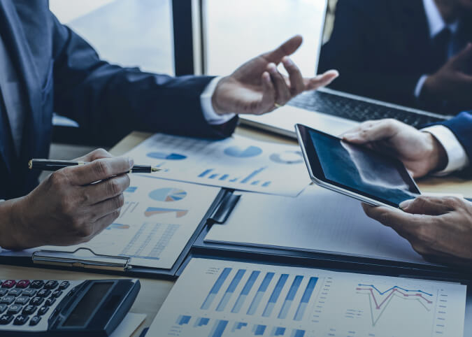 two people sitting at a table going over statistics